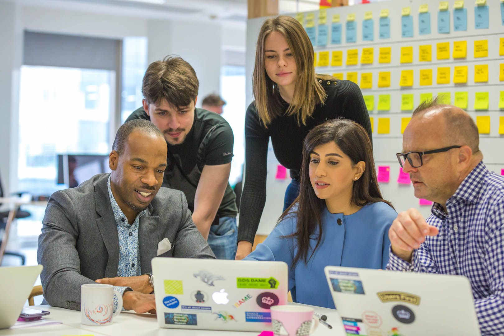 Five Civil Servants collaborating on a Fast Stream project