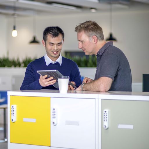 Two colleagues discussing work using a tablet