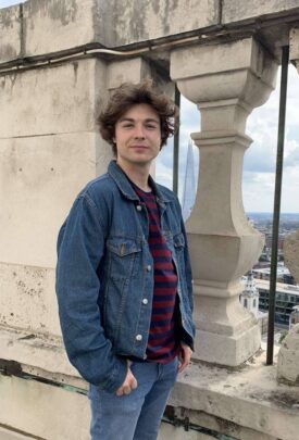 Kieran standing in front of a pillar looking at the camera