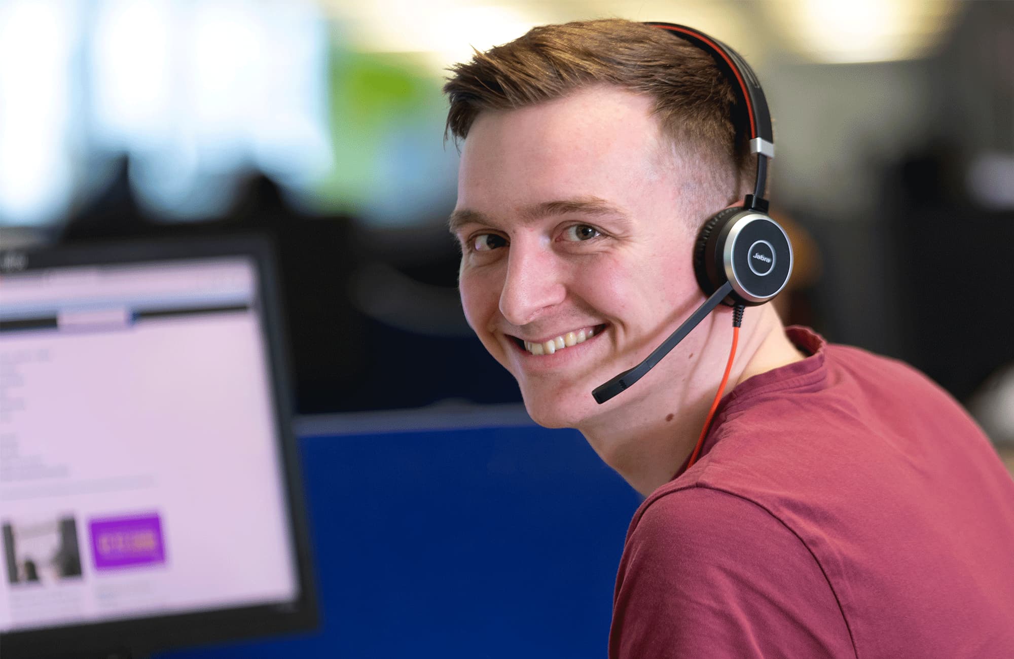 Customer Service advisor smiling wearing headset