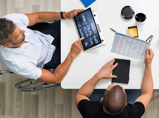 birds eye view of employees using laptops