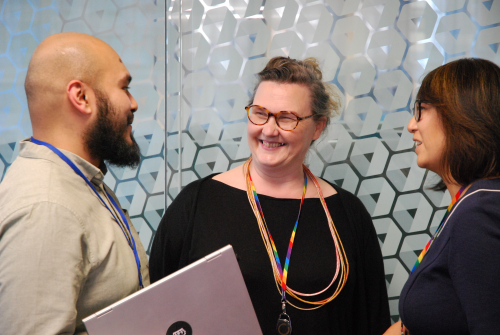 Three colleagues chatting at work