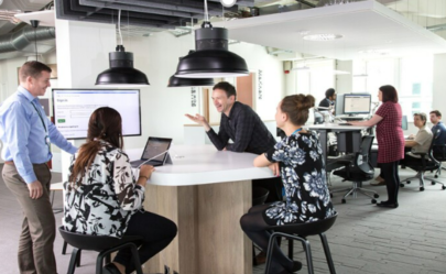 Employees Working Together Around A Screen