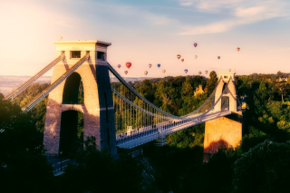 Decorative image: a photo of Clifton Suspension bridge, with hot air balloons in the background
