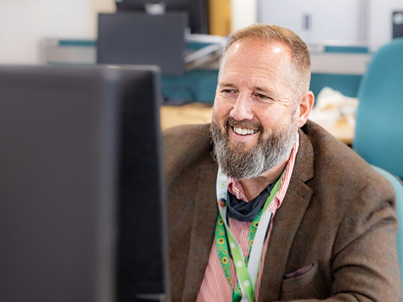A member of the DVLA Estates Management Group (EMG). He is wearing a sunflower lanyard to indicate a hidden disability.