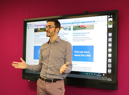 A CMA graduate employee giving a presentation