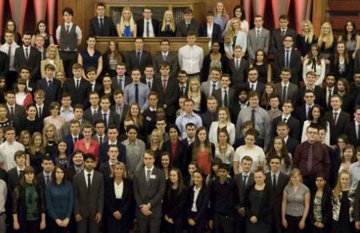 Apprenticeships -  A professional photo of a large group of people in business casual dress, they are all looking towards the camera and smiling.