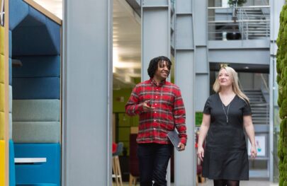 colleagues walking through a bright and modern hmrc office
