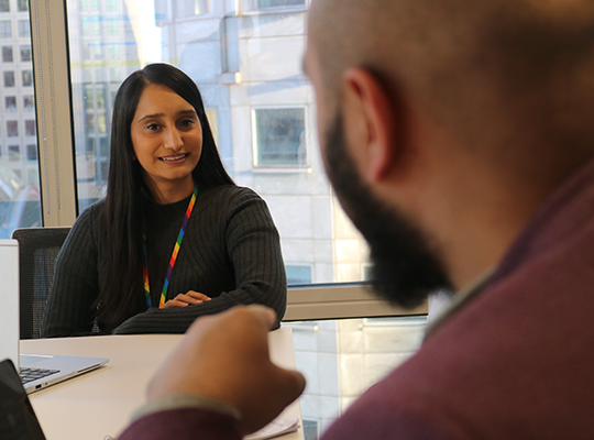 A photo of a CMA intern sitting with a colleague