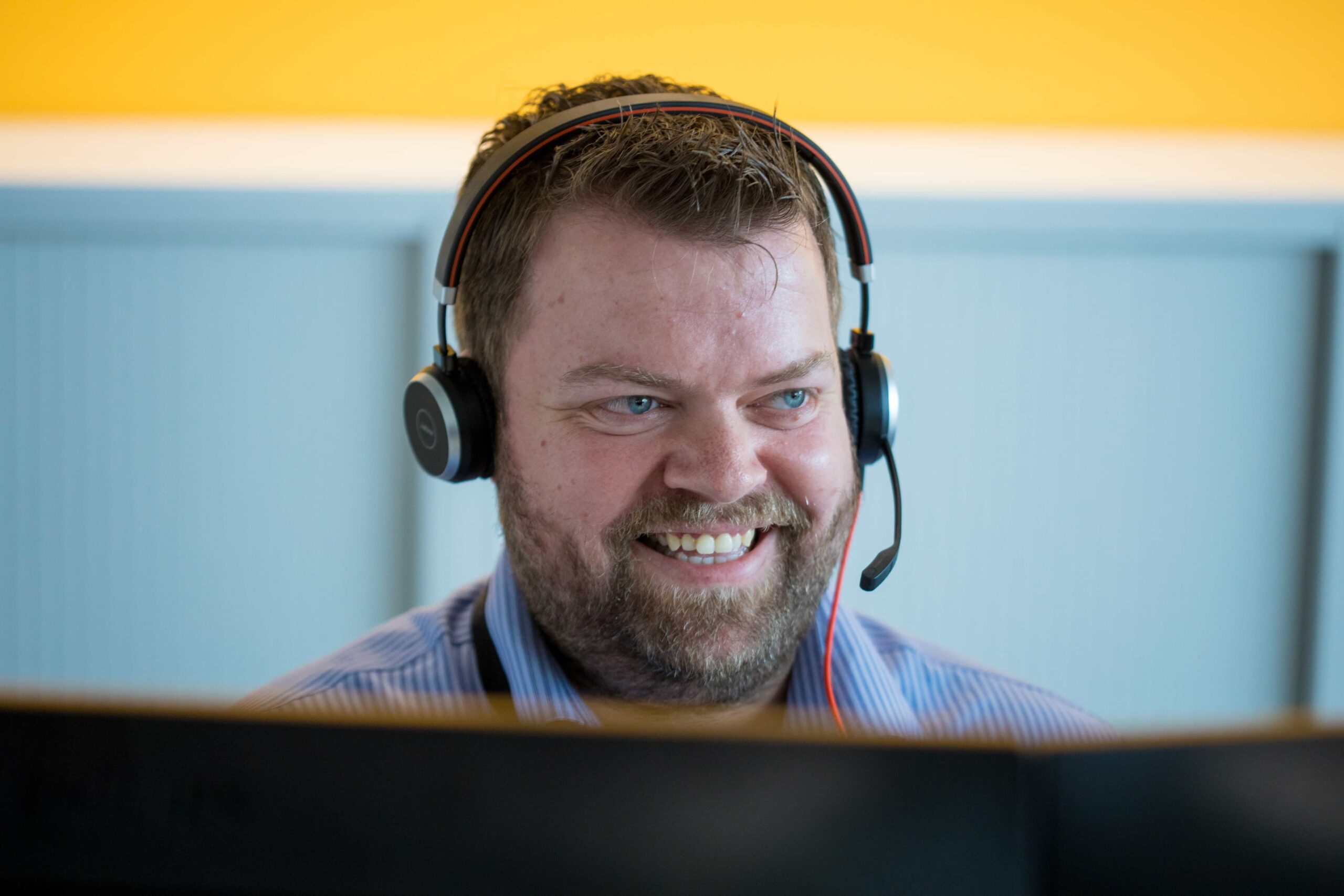 man smiling wearing headset