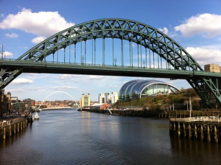 Decorative image: Photo of a bridge over a placid river