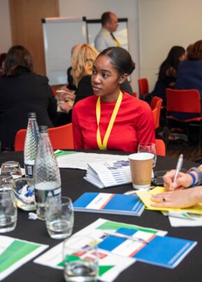 A group of colleagues working at a table together on a planning task