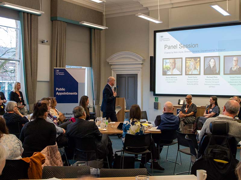 A Public Appointments panel session being chaired by Nick Joyce, the Director General of the Department for Transport. There is an engaged audience, all dressed formally.