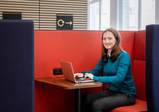 woman sat at desk working on laptop