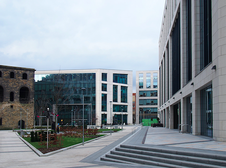 The historic railway lifting tower surrounded by modern buildings at Wellington Place in Leeds