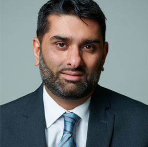 Photo of Maqsood Khan. He has a dark beard and dark hair. He is wearing a dark suit and white shirt