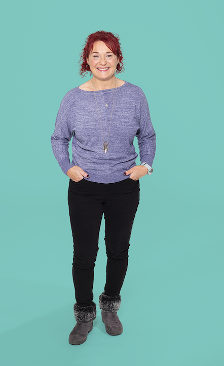 Decorative image - a photo of Gayle Roddis - a veteran. She is wearing a lilac sweater and black jeans. She has red hair and is smiling.