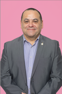 Decorative image - photo of Stephen Commander - veteran, he is wearing a grey suit-jacket over a lilac shirt. He is smiling