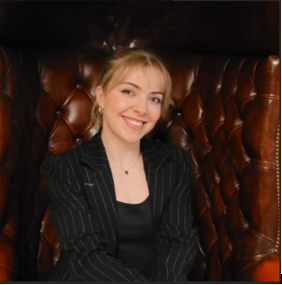 Decorative image: A DCMS intern smiling, she is looking at the camera.