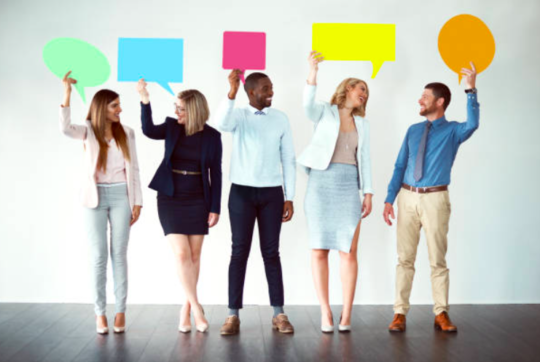 Decorative image: Five people in a line facing the camera, each holding a cut-out of a thought-bubble in a different colour card.