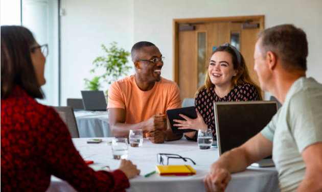 A team of people chatting at a table