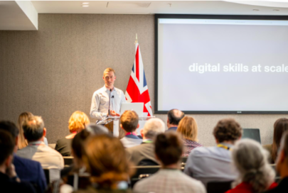 A photo of Thomas Beautyman, Deputy Director, Government Digital Capability, CDDO, presenting to a room of collagues