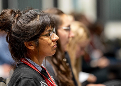 Decorative image: a row of colleagues listening to a speaker at an event