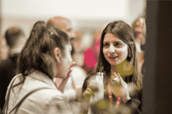 Two women in conversation at a networking event