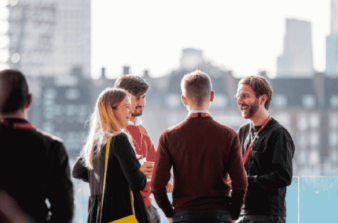 A small group of people in conversation at a networking event