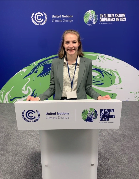 Photo of Emma Macrae Assistant Statistician, Environmental Standards Scotland. Emma is standing behind a lectern, on a stage