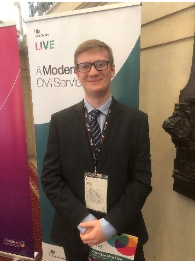 Photo of James, a Commercial Graduate. He is pictured at a Civil Service Live event, looking happy and relaxed.