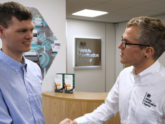 Two VCA colleagues shaking hands in front of a VCA reception desk.