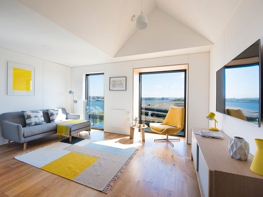 A photo of inside a New Build Home. It is light and airy, with large windows.