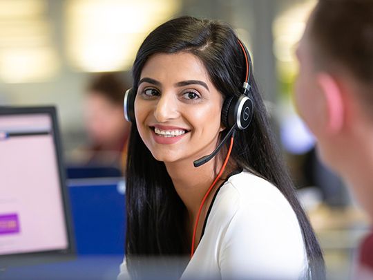 Female HMRC Employee In A Customer Contact Centre Using A Headse