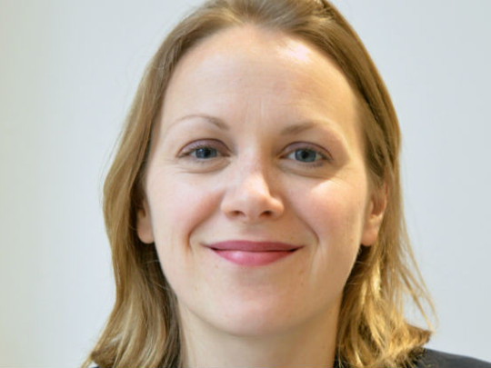 A photo Of Claire Morris. She has blonde shoulder-length hair and is smiling.