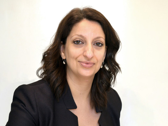 A photo Of Phillipa. She has dark hair and eyes, and is wearing a black blazer with a turned up collar.