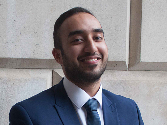 A portrait Of Sameer (Finance Apprentice at HM Treasury) outside Treasury building