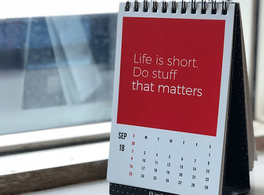 A photo of a desk calendar opened to a page which reads "Life is short. Do stuff that matters."