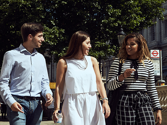 Three Government Communications Team Members Walking in Westminster on a sunny day