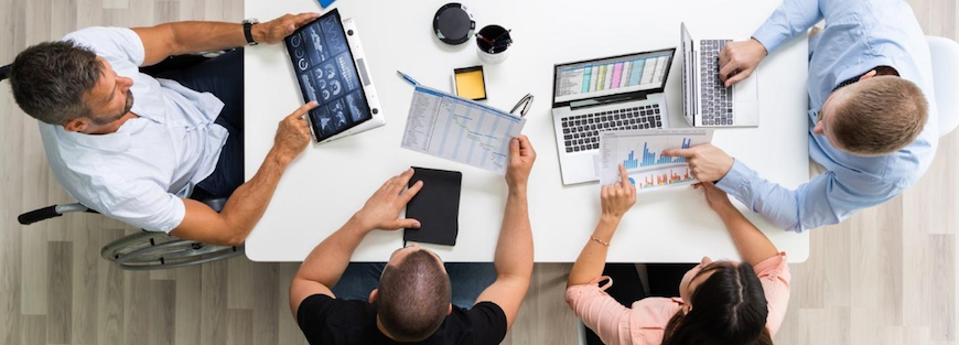 Bird's eye view of hmrc colleagues working around a table