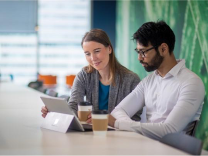 colleagues talking over a tablet device