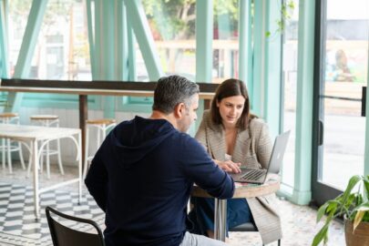 Man and woman sitting at a desk in an office
