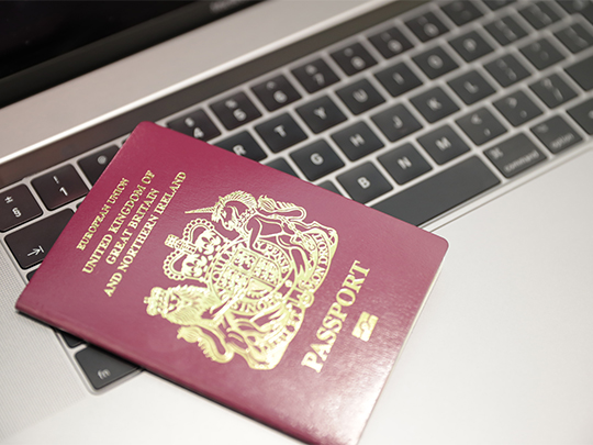 Passport On Laptop Keyboard