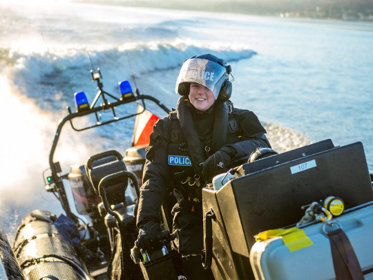 Police Officer On Speedboat