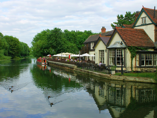 Pub By River In English Countryside