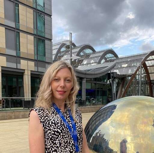 Sonia Pawson stands in front of a government building