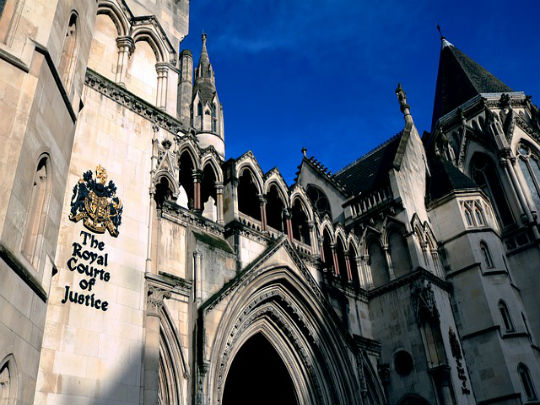 A photo of the Royal Courts Of Justice, under a clear blue sky