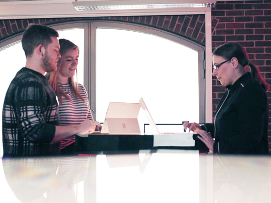 Three Security Profession Team Members working on laptops together