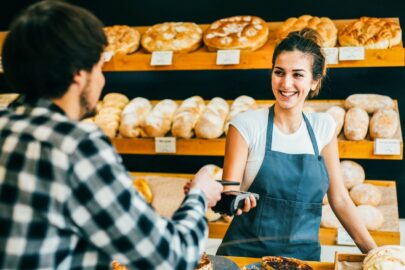 Young Man Making A Contactless Payment At A Bakery