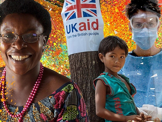 Uk Aid Woman Smiling Boy Leaning Against Tree Woman In Protectice Laboratory Wear